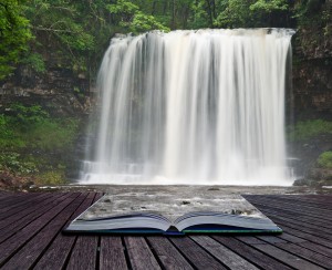 Creative Concept Image Of Waterfall In Woods In Pages Of Book